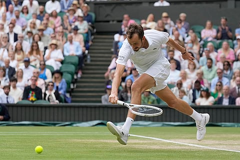 Daniil Medvedev plays a backhand return to Carlos Alcaraz